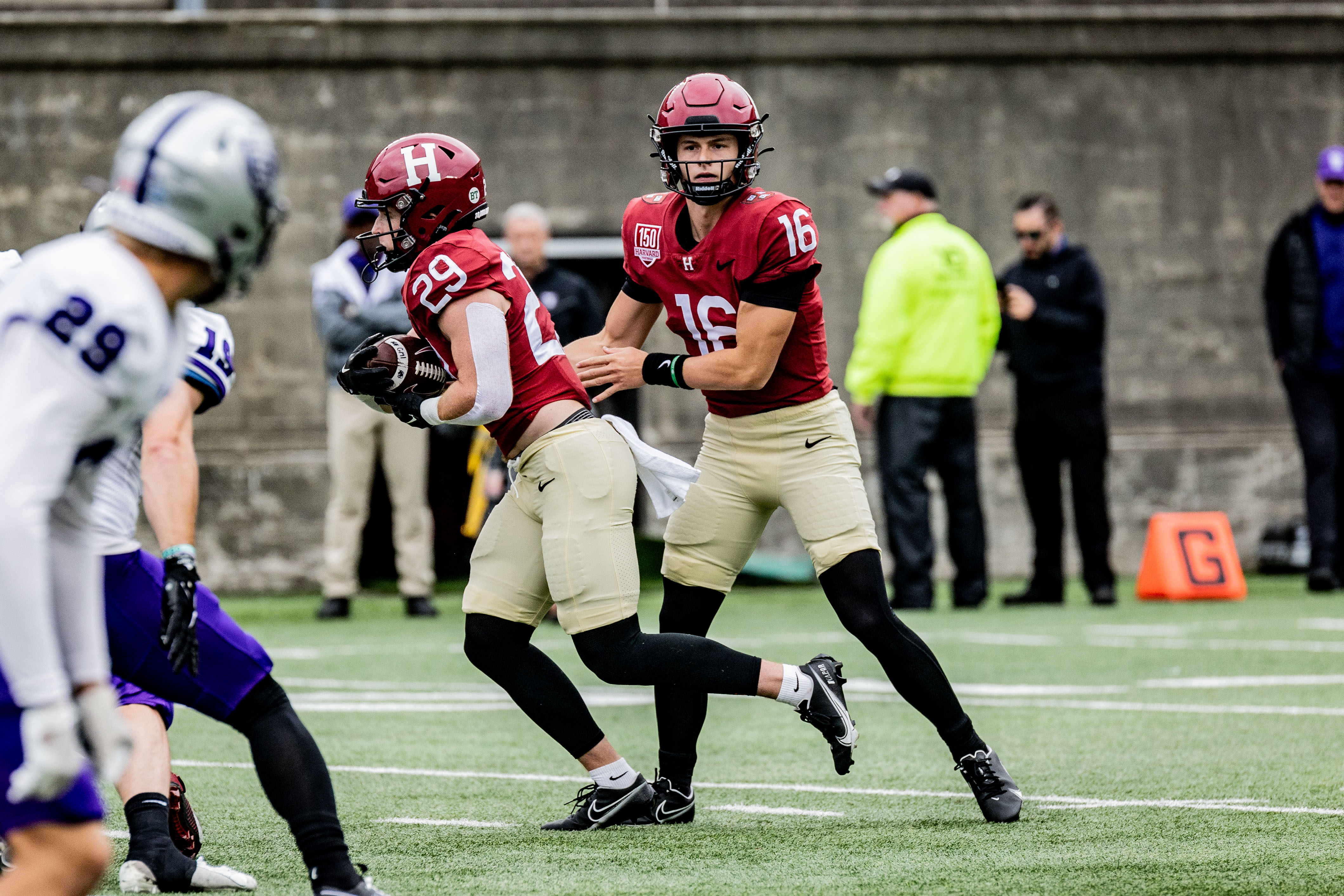 Harvard player 29 runs with ball