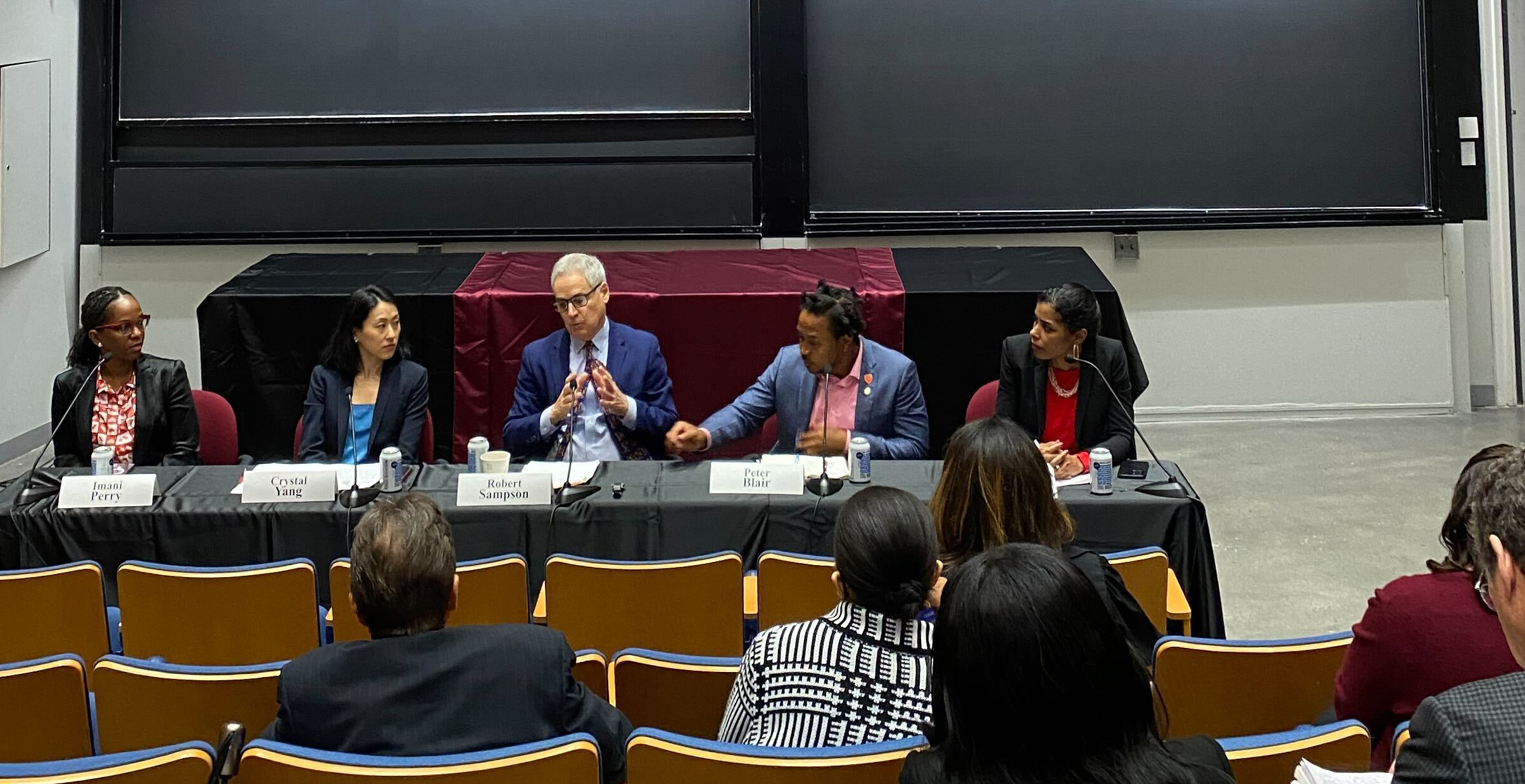 five panelists talking to audience