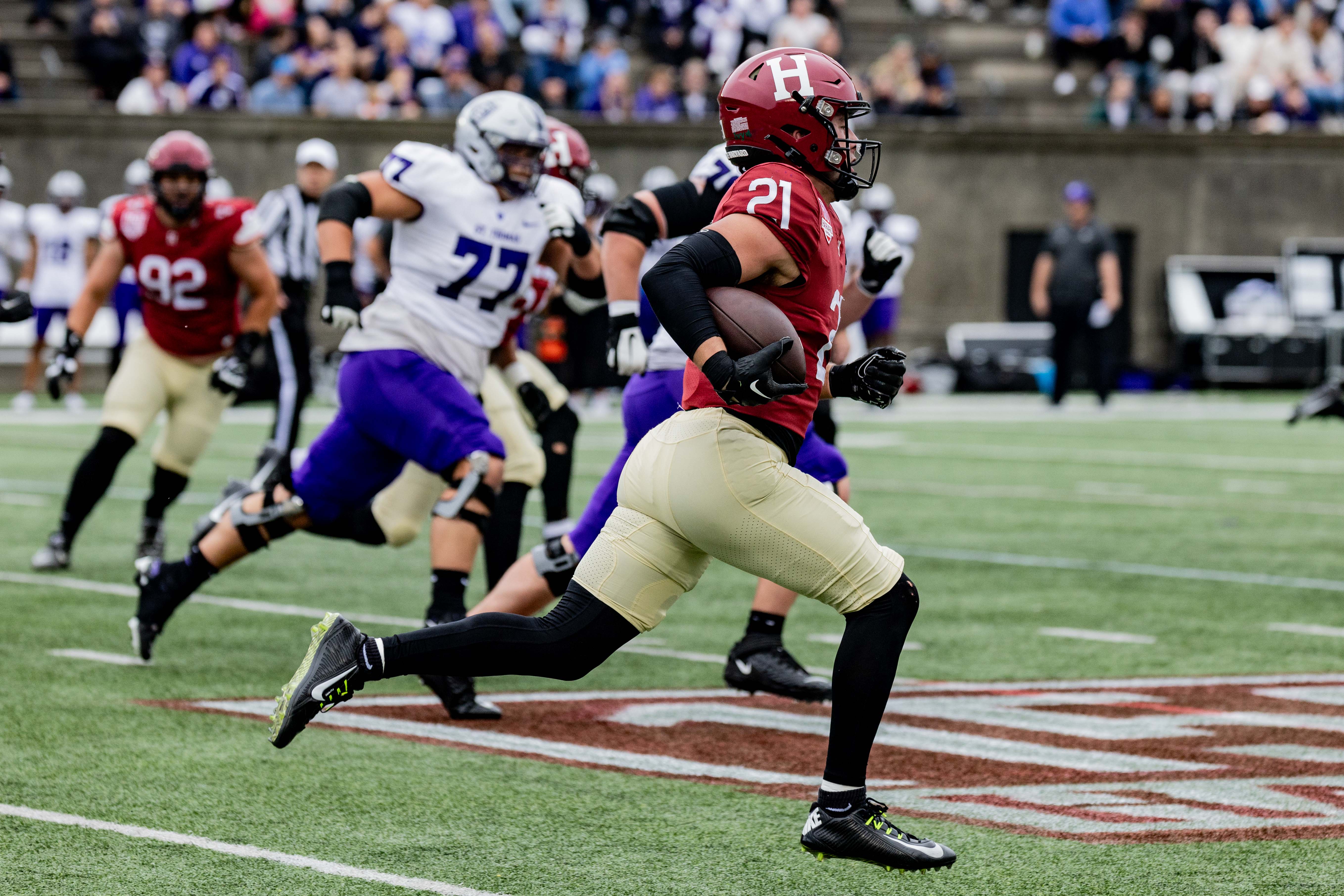 Harvard sophomore safety Ty Bartrum runs an intercepted St. Thomas pass back 96 yards for a touchdown.