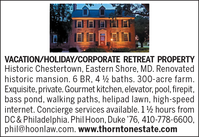 Brick colonial style home at dusk. Vacation/holiday/corporate retreat property. 