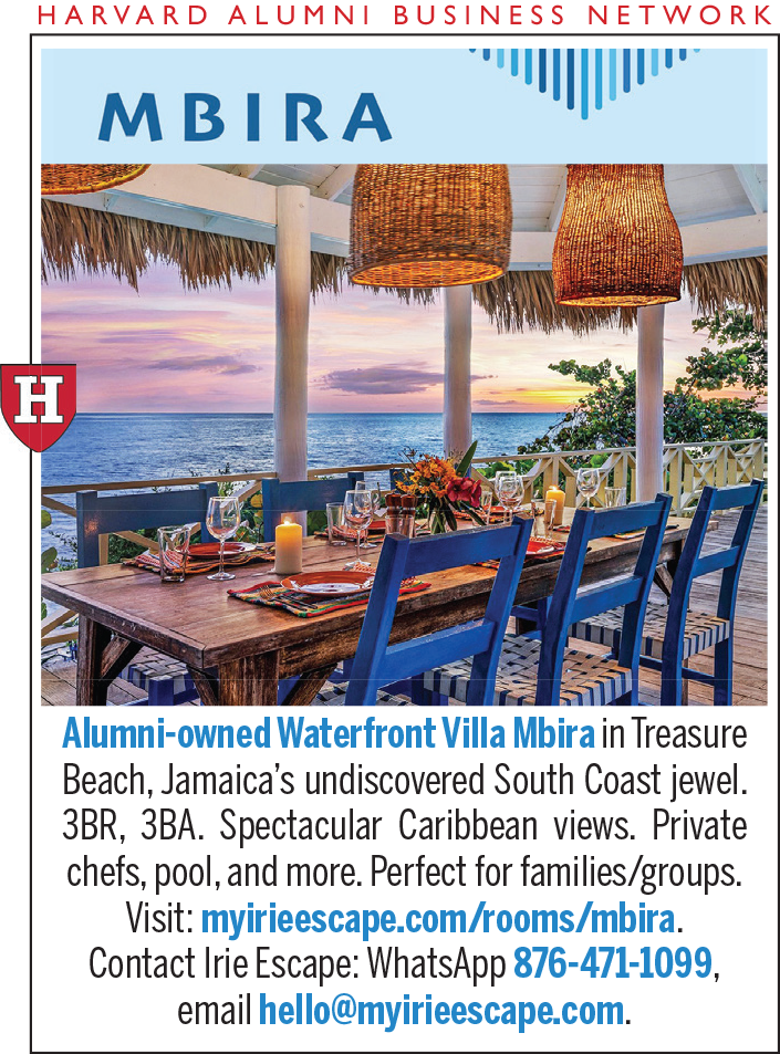 Colorful dining area overlooking the Caribbean Sea, featuring wooden chairs and tropical decor.