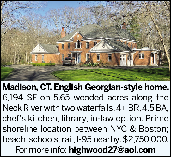 Brick Georgian-style home surrounded by trees on a large property in Madison, CT.