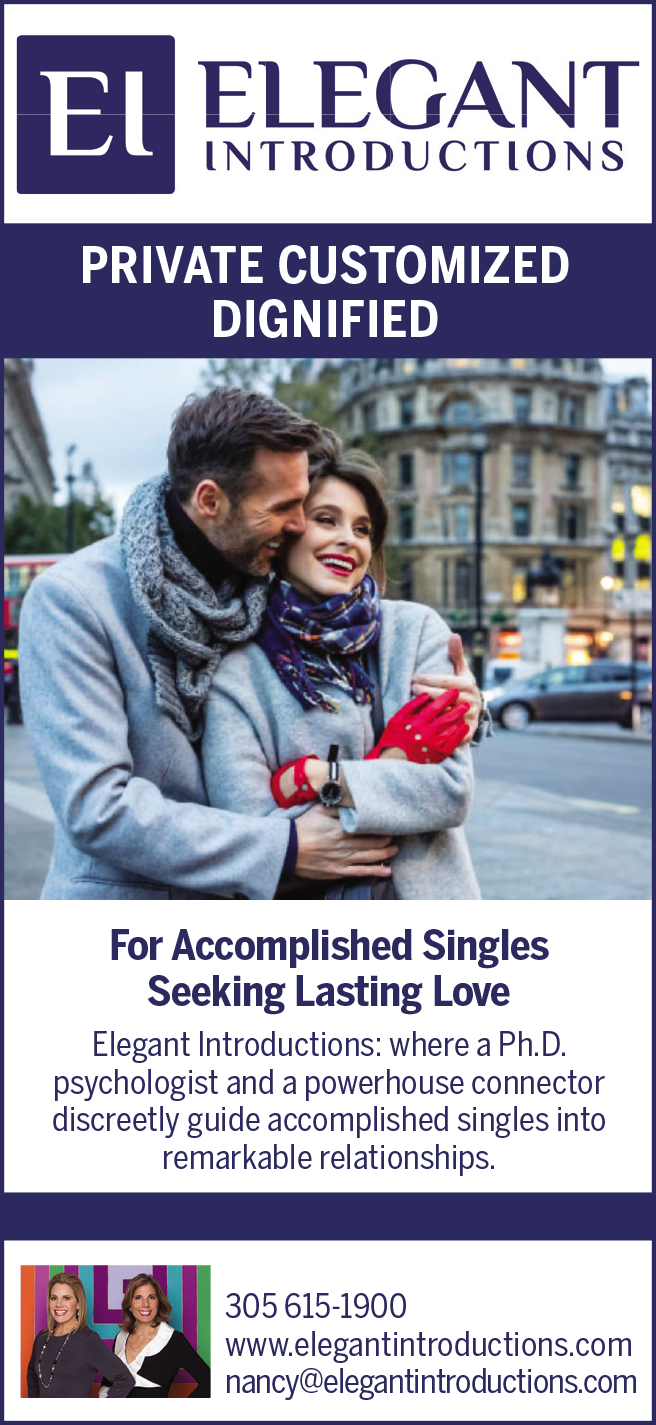 A couple smiling warmly outdoors, wrapped in cozy clothing, sharing a moment together.