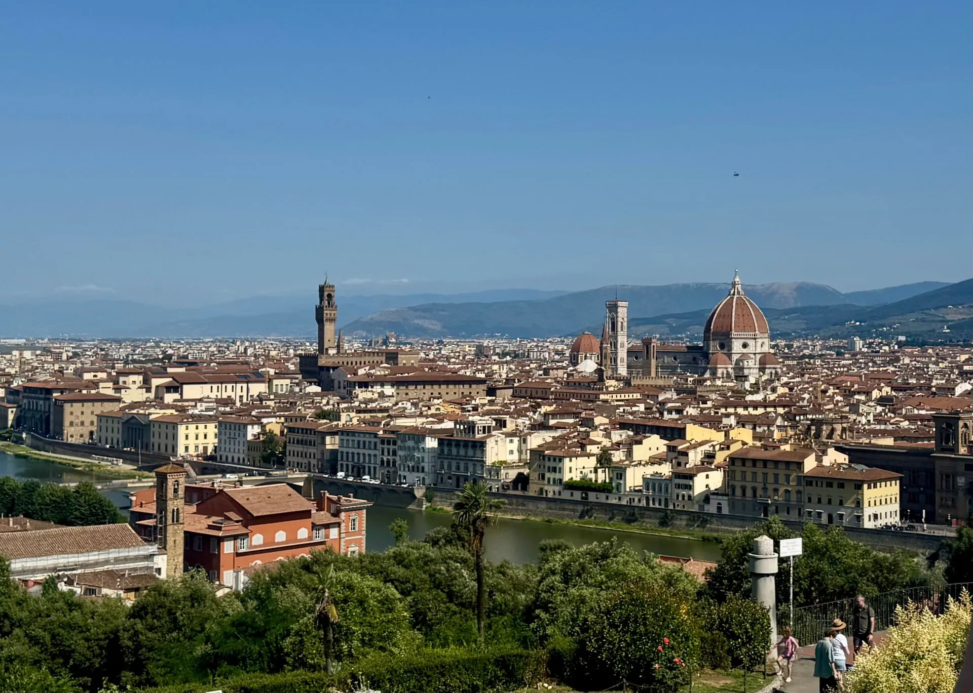 Panoramic view of Florence, Italy, featuring its iconic architecture and blue sky.