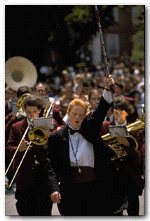 Drum major Catharine Hornby '97 and the hard-working Band lead children of twenty-fifth reunioners to the day's next events after lunch en famille at Eliot House on Wednesday. Overheard, a father to a fussy child: 