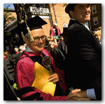  Staff work. University marshal Richard M. Hunt, Ph.D. '60, carries a symbol of office, a bit of ritualistic paraphernalia called a 