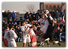 Harvard parlayed two corner kicks into goals in the NCAA tournament rematch with Boston University. Above, back Lee Williams (7) heads Will Kohler's kick as Rich Wilmot (right) screens BU goalkeeper Bryan Murphy. Back John Vrionis (2) headed in the game-w