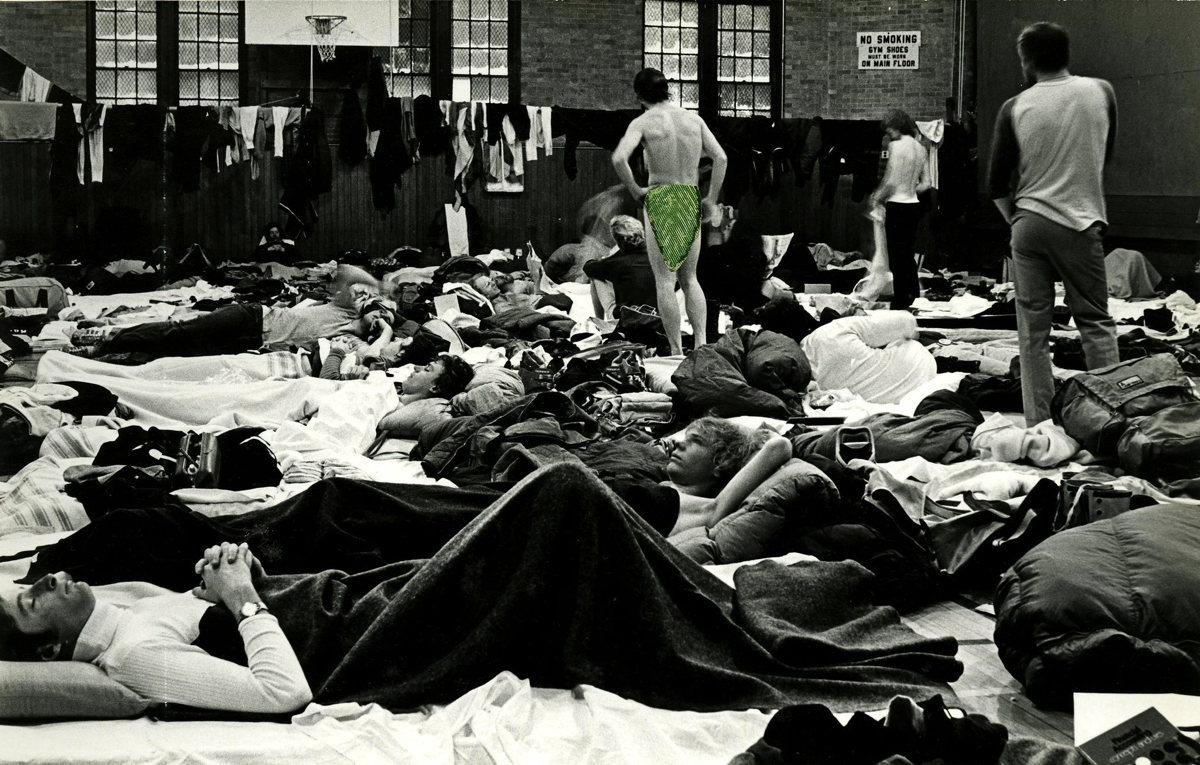 group of Harvard skiers sleeping in close quarters at a Carnival circuit