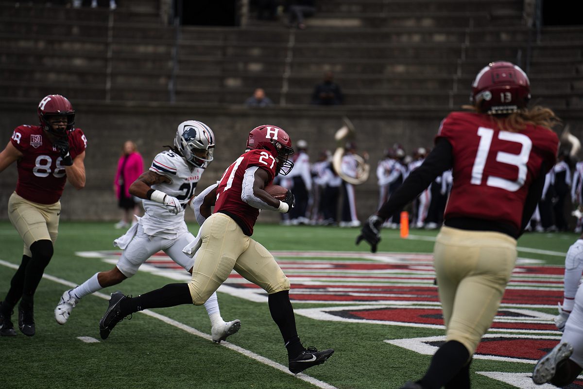 Harvard player with ball runs into the end zone for a touchdown