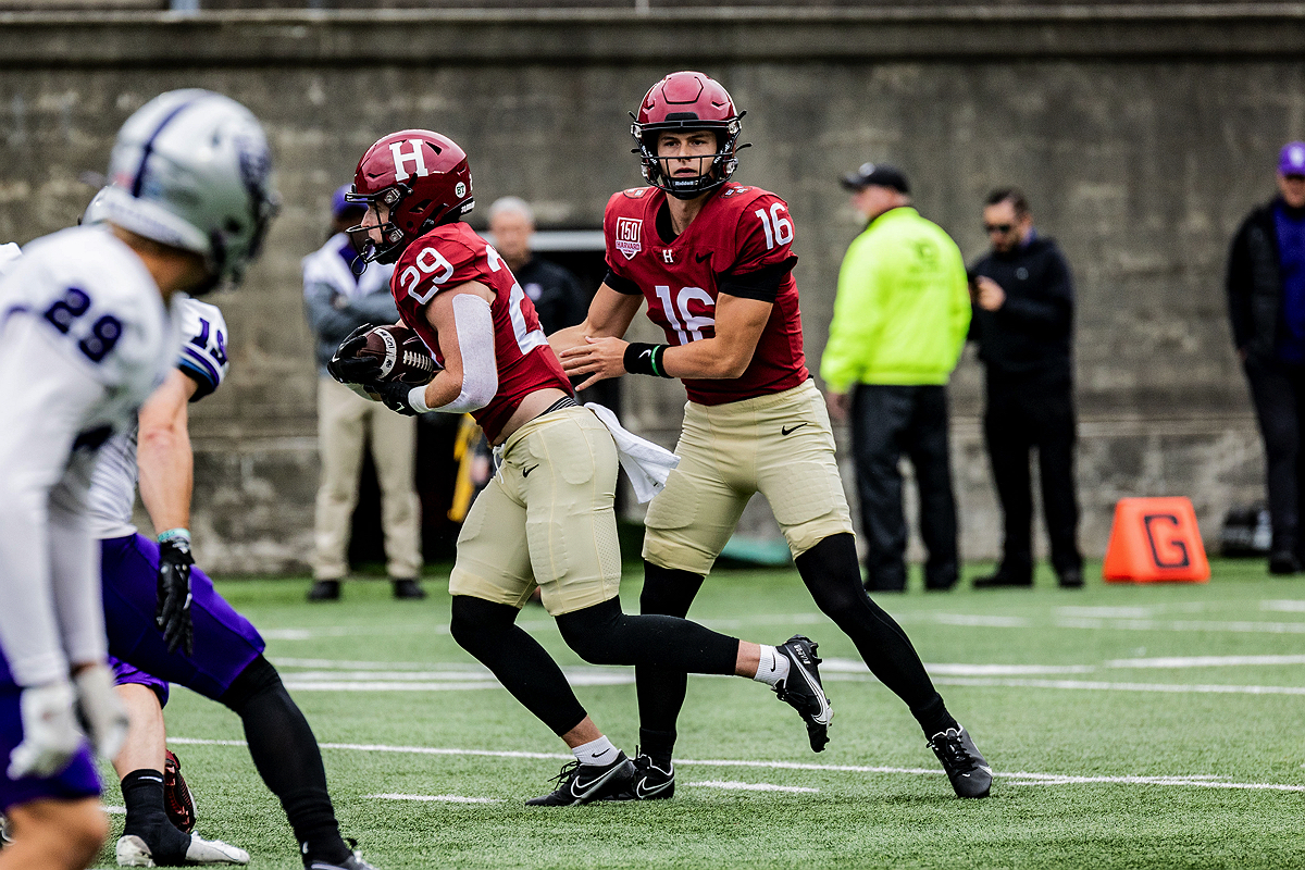 Harvard player receives ball handoff from another player