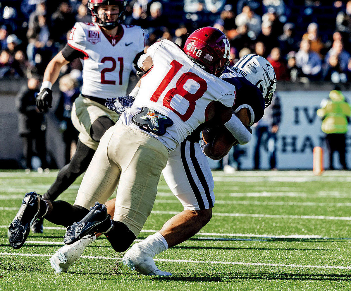 Senior defensive back Kaleb Moody (18) corrals hard-running Yale back Joshua Pitsenberger.