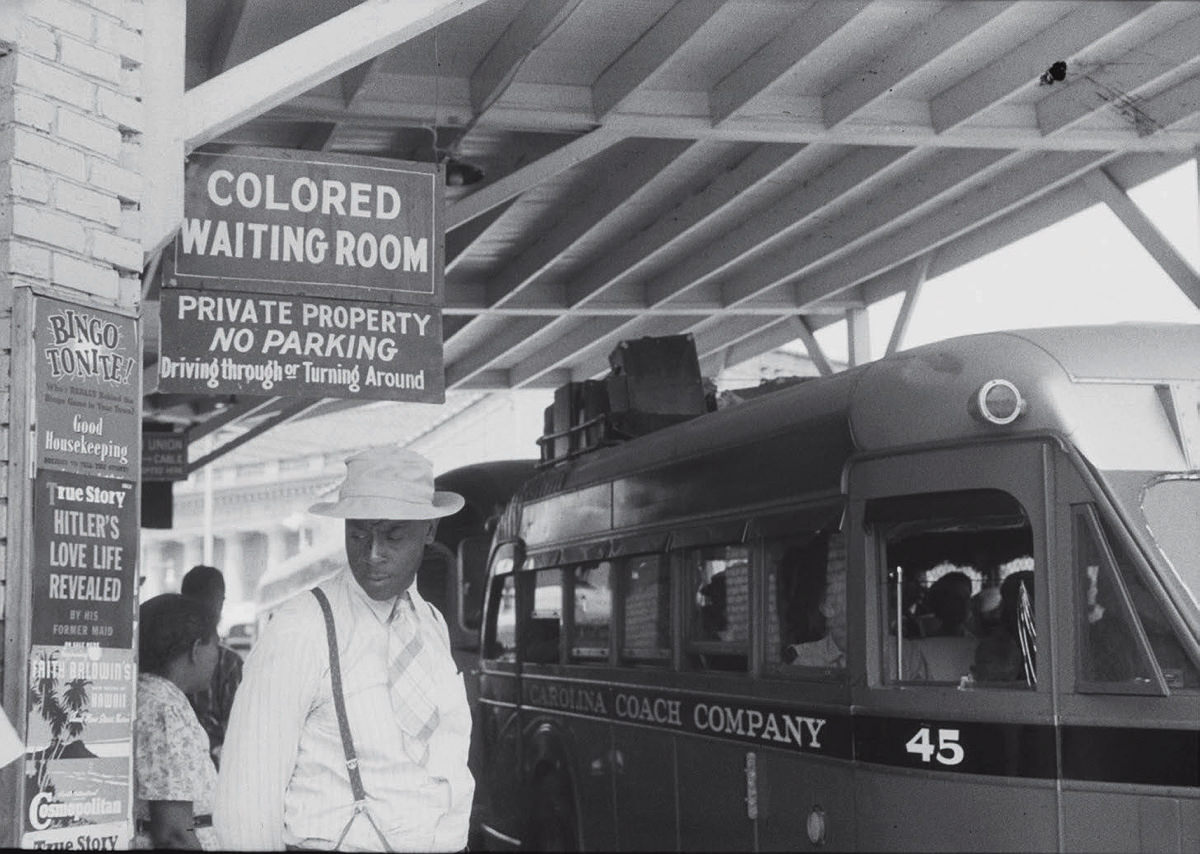 A black man standing outside a Durham, North Carolina bus waiting room