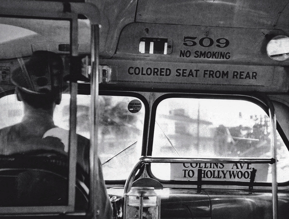 A Miami bus with a sign stating "colored seat from rear”