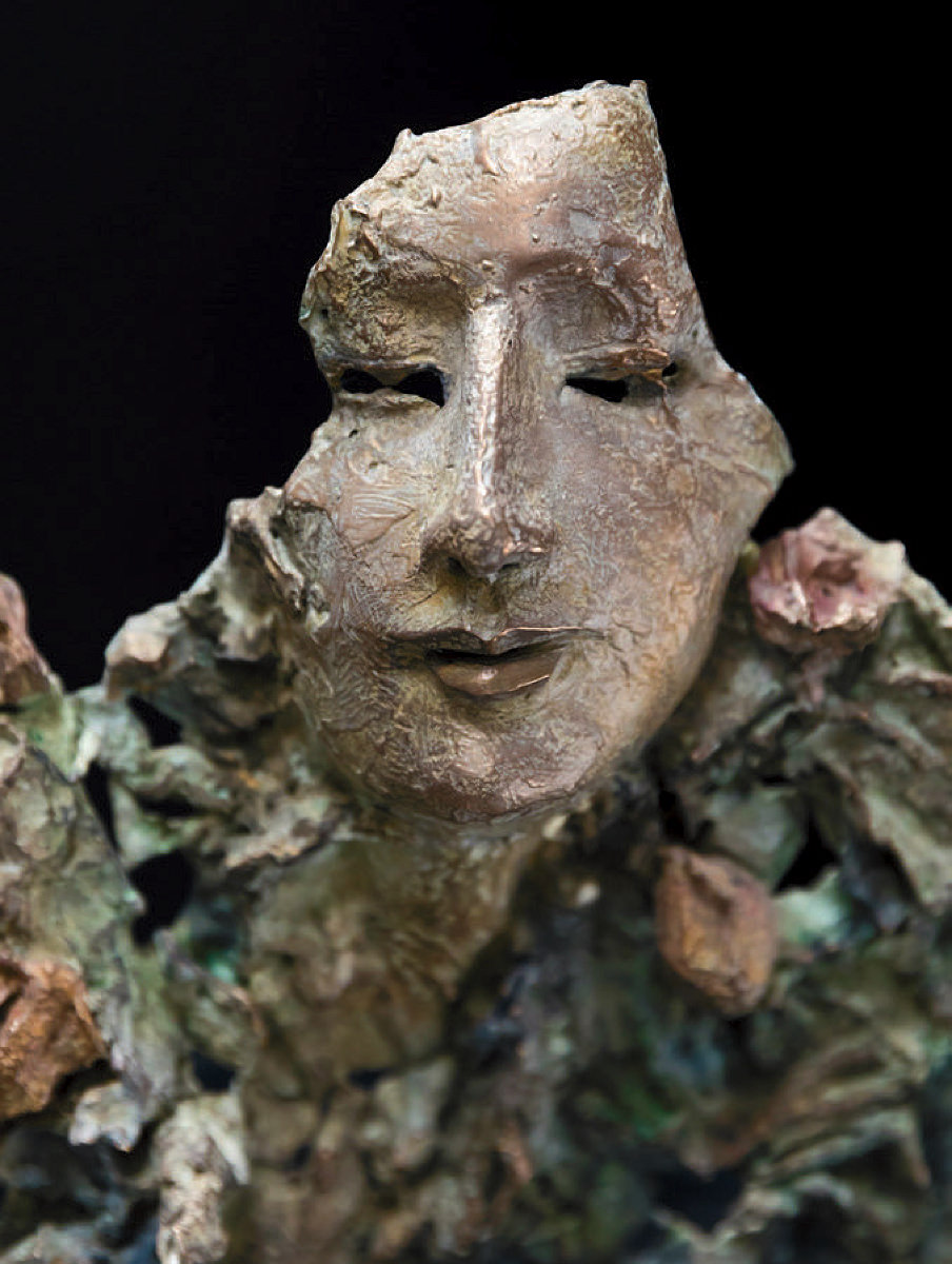 A bronze sculpture of a face