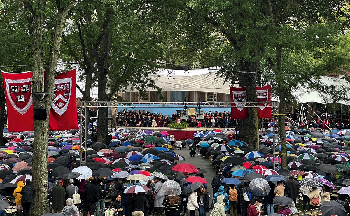 Tercentenary Theatre full of people with umbrellas