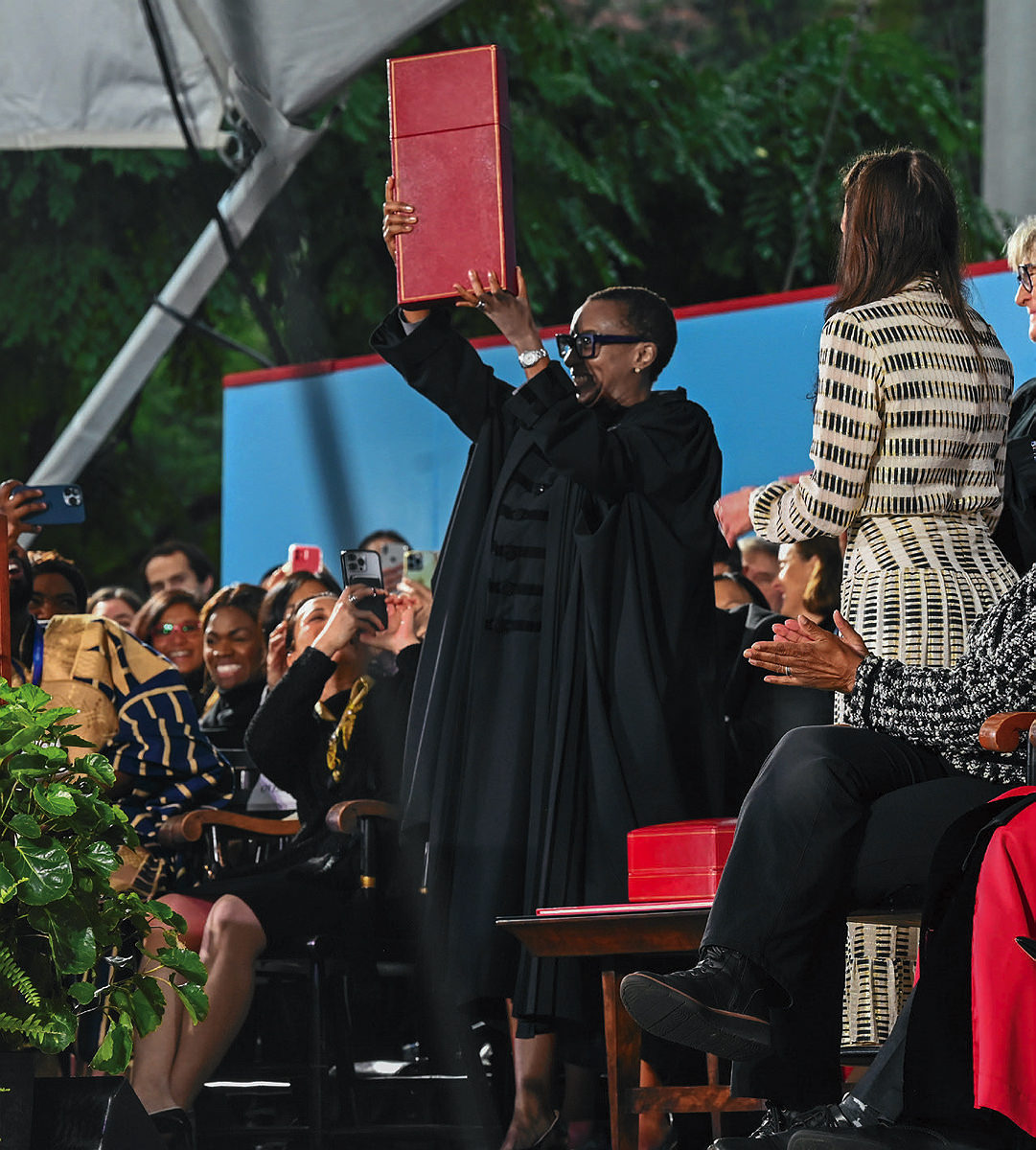 President Gay on stage holding up red box 