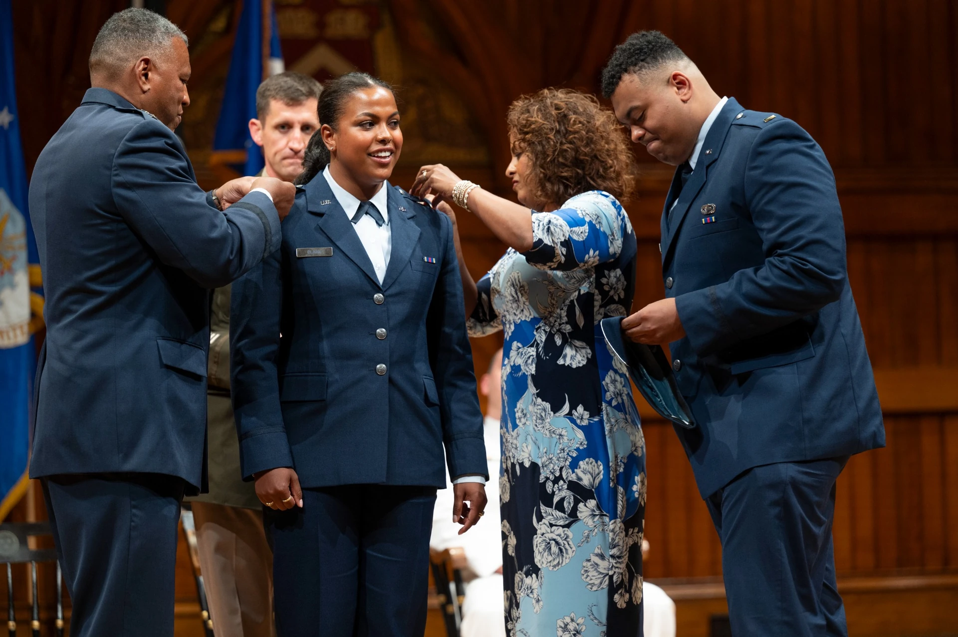 Family gathers around cadet during pinning ceremony