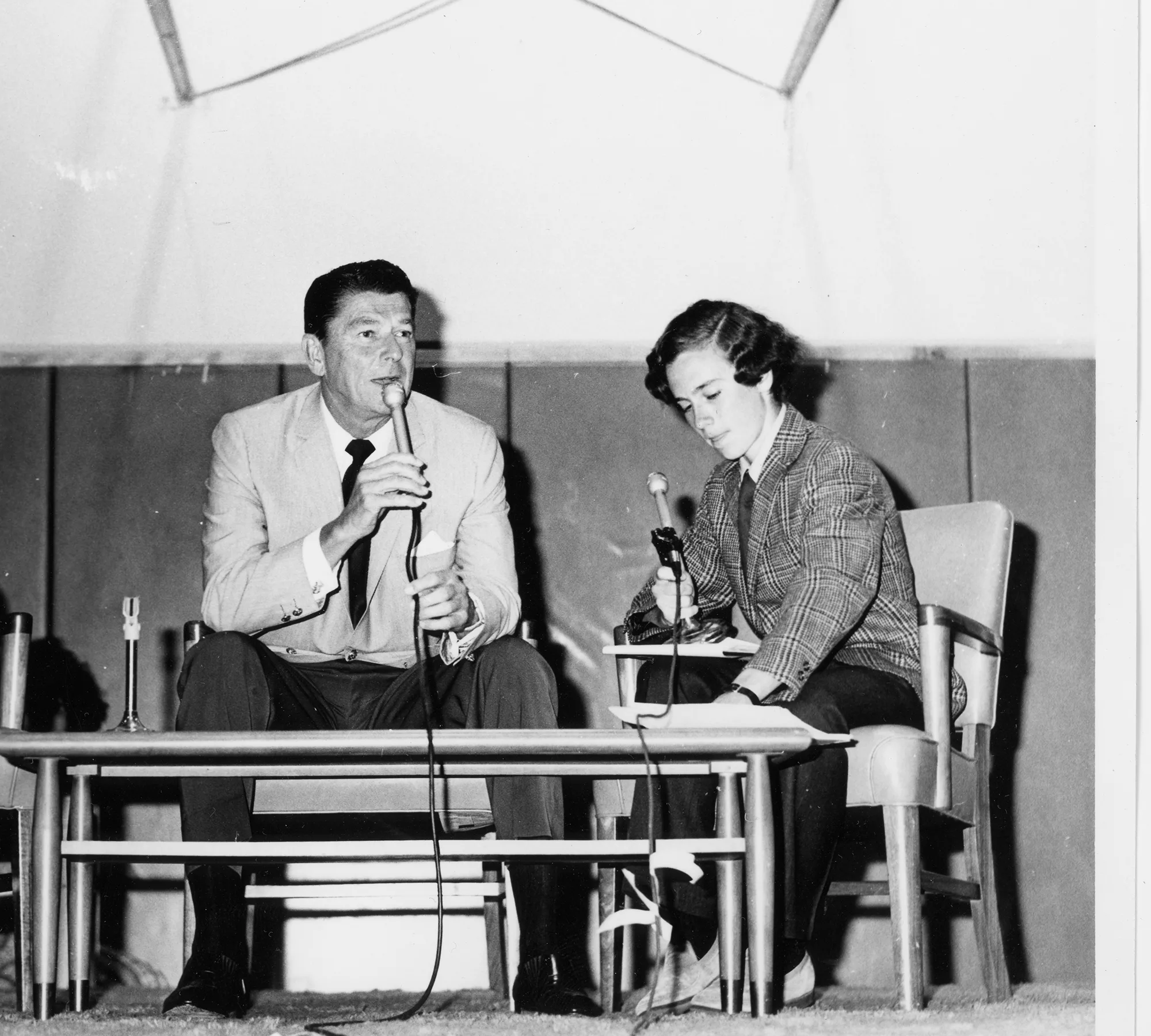 Ronald Regan and Michael Sandel at a debate table in 1971