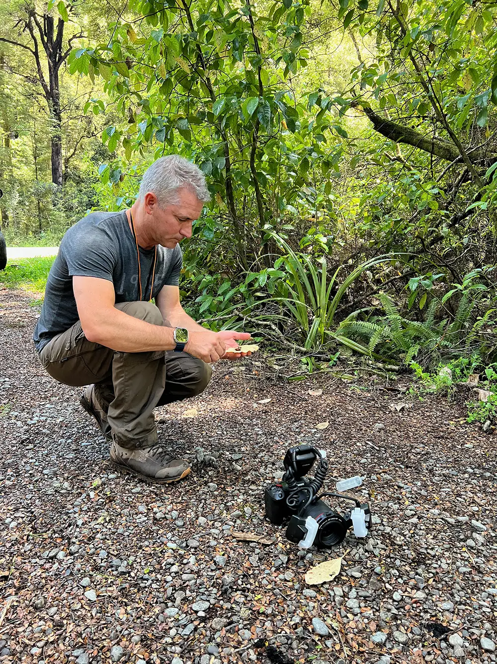 Giribet in field with camera equipment on ground