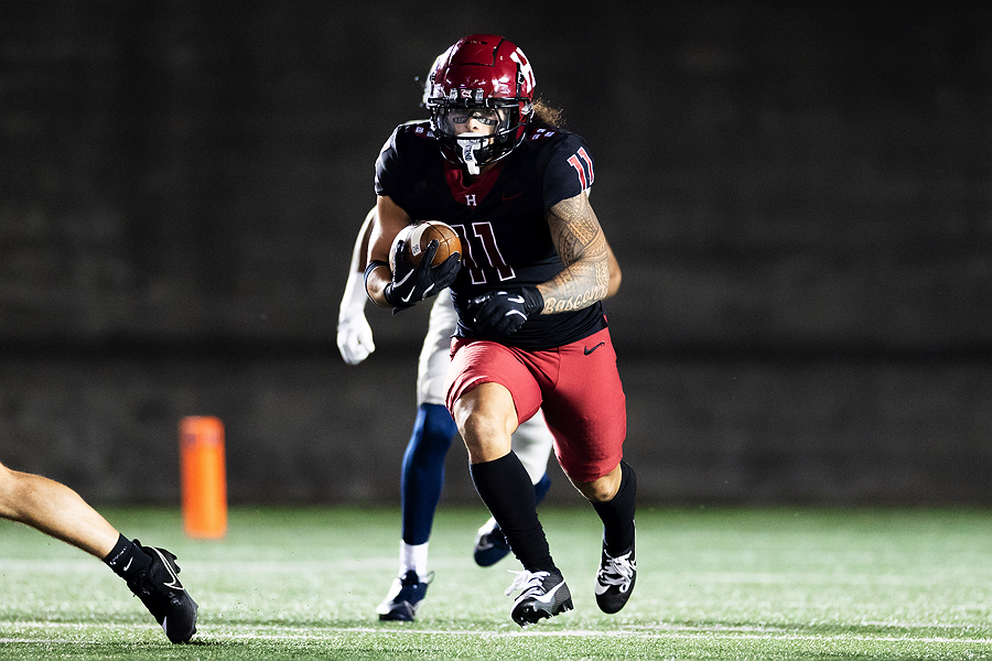 Harvard player 11 runs with the ball