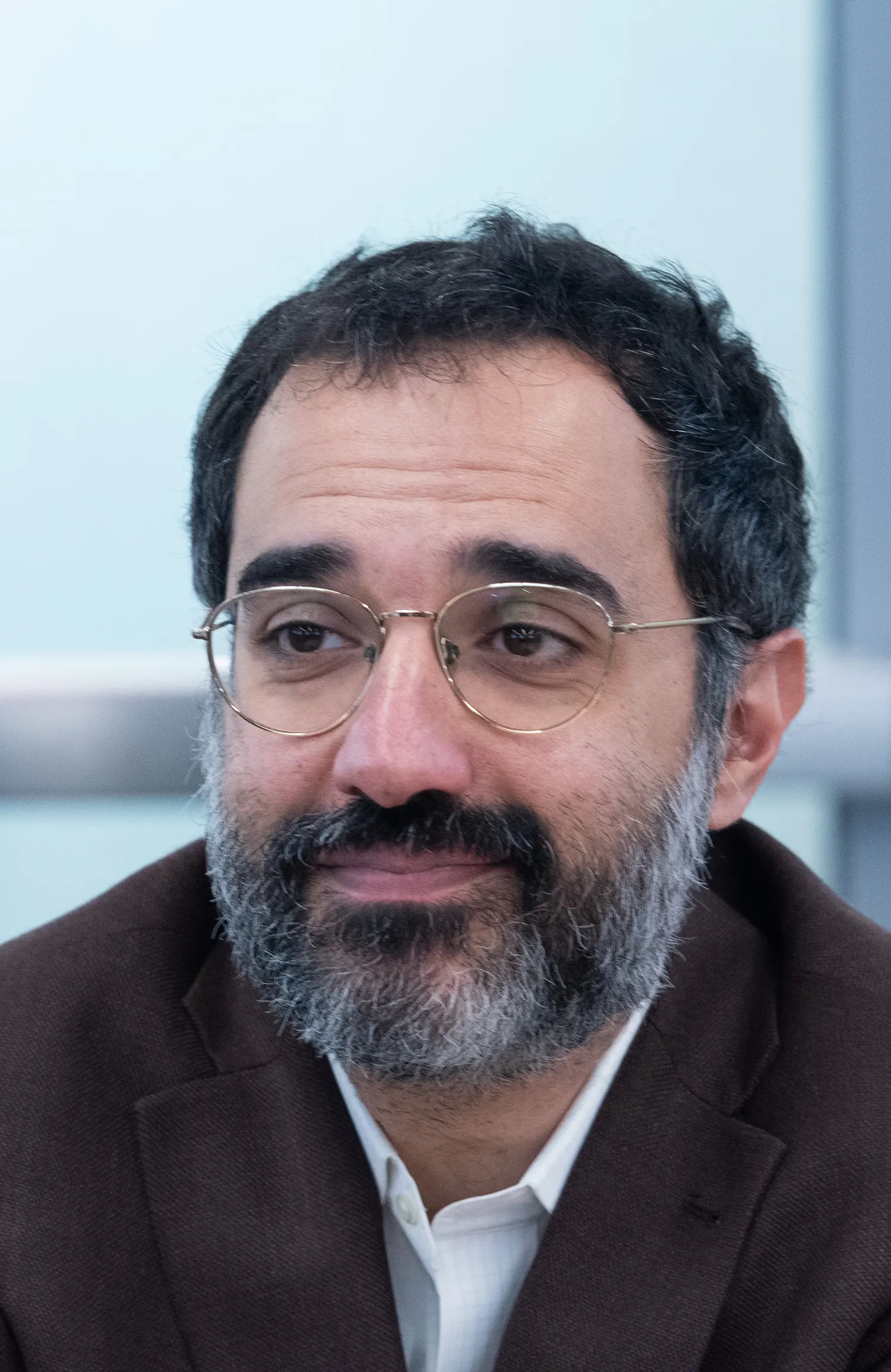 Teddy Svoronos sitting at a panel table