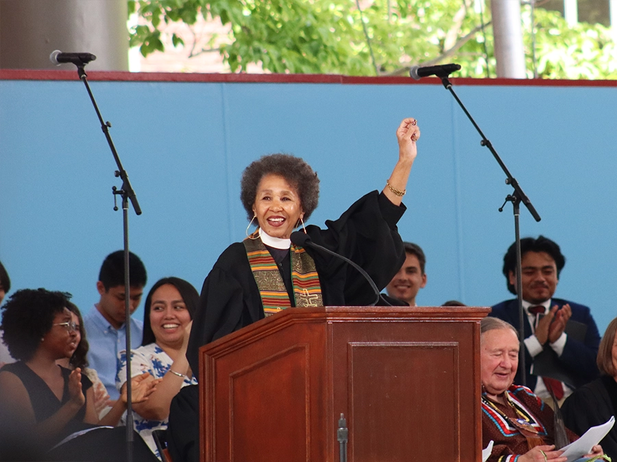 Gloria White-Hammond waves her hand in the air as she speaks at a podium