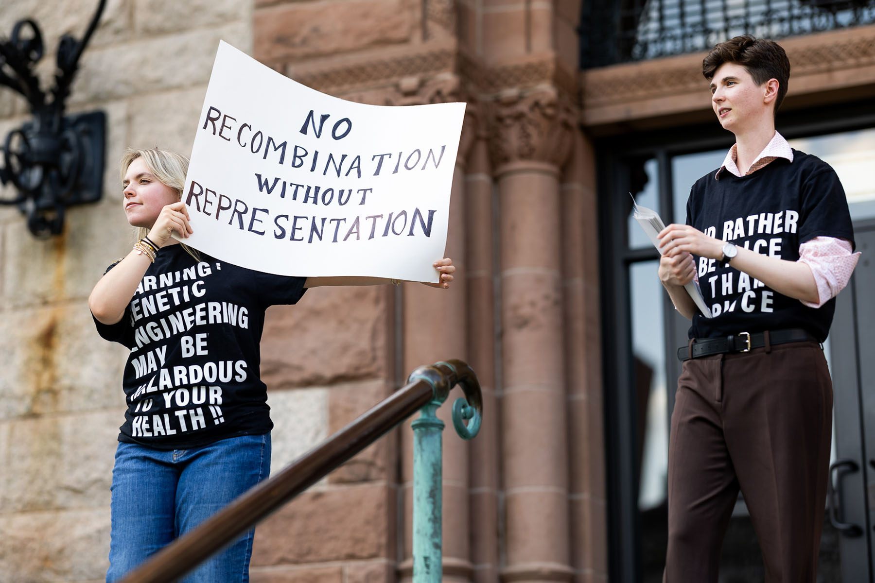 Protesters hold anti-genetic-engineering sign outside government building