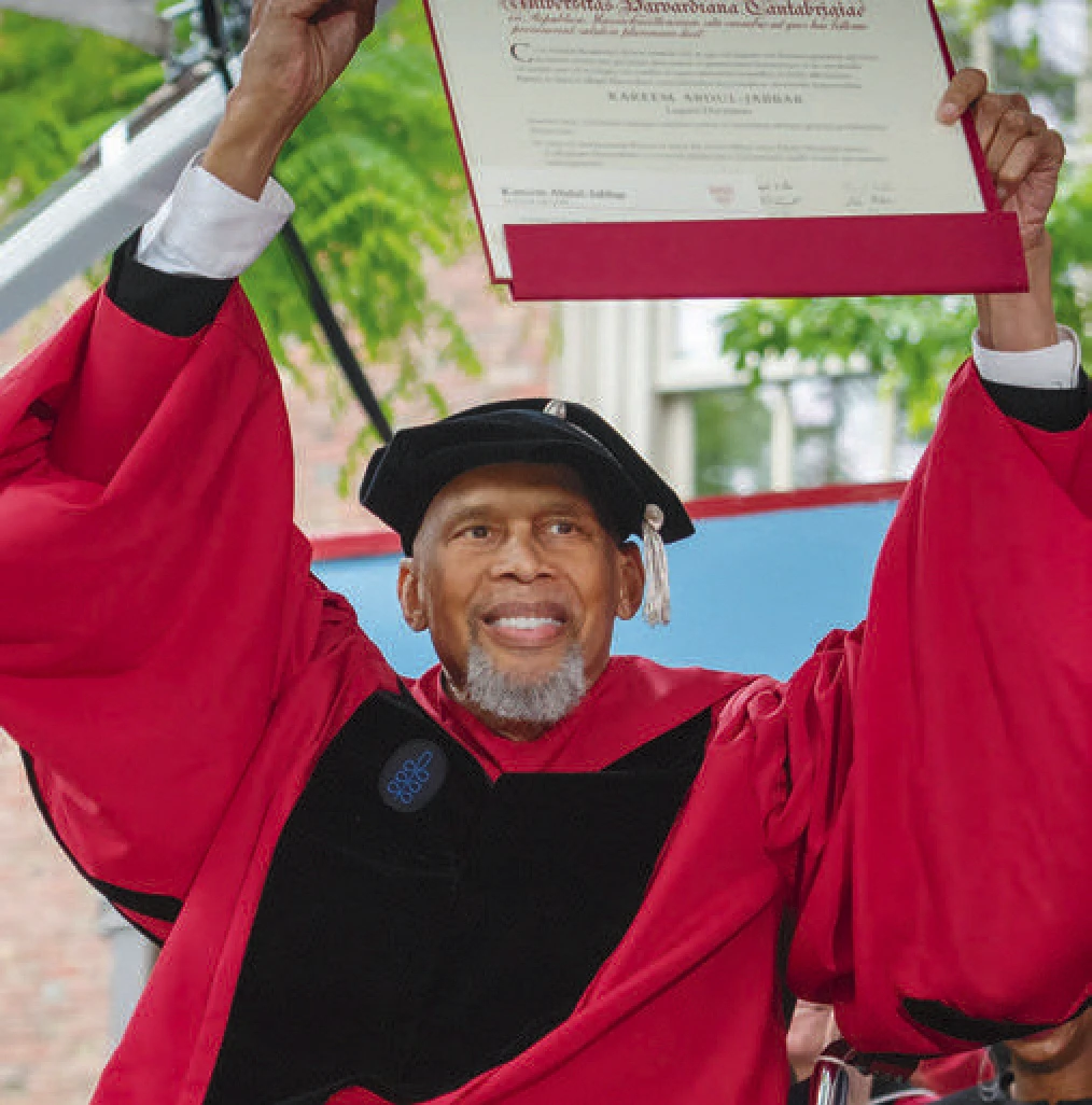 Kareem Abdul-Jabbar holding up his honorary degree