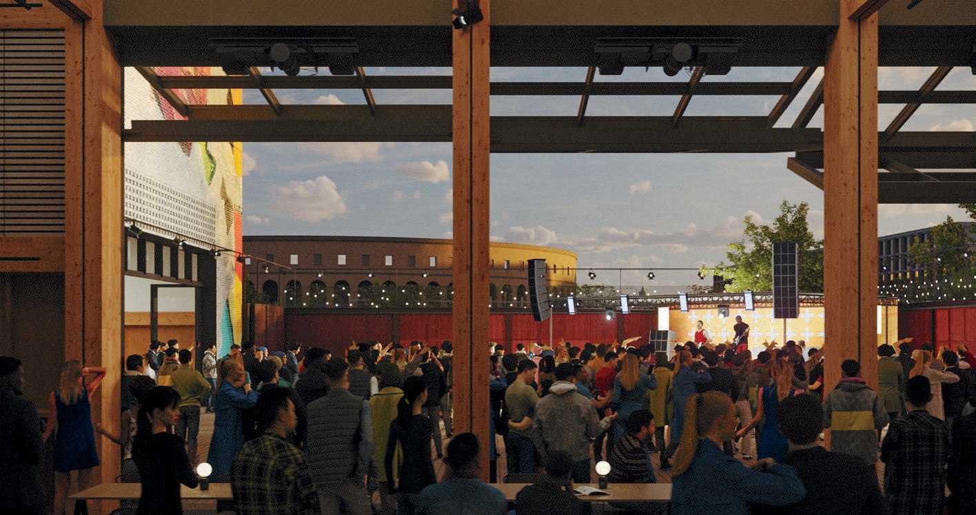 rowded indoor-outdoor concert venue with timber columns, stage lighting, and an audience at dusk.