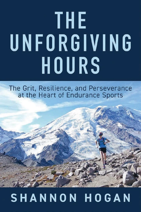 Book cover for "The Unforgiving Hours" by Shannon Hogan with a woman running on a mountain against a navy blue background