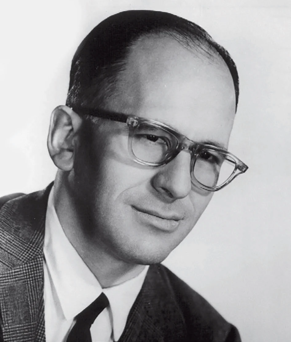 A black and white photo of a man wearing glasses
