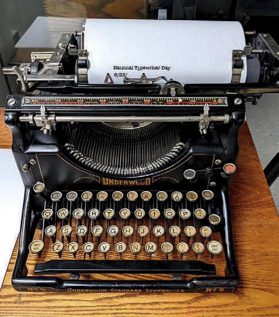 Classic Underwood typewriter with paper inserted, featuring a typed note about National Typewriter Day.
