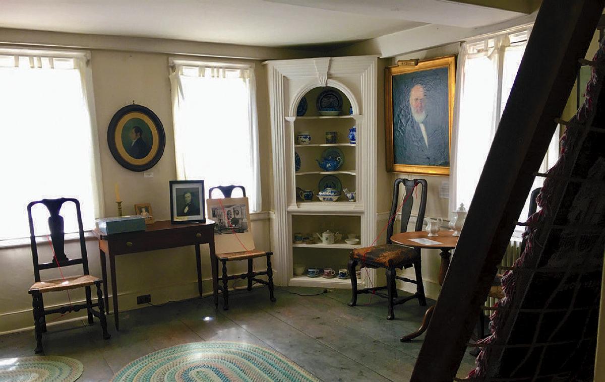 Room at the Whittier Birthplace house with antiques and paintings