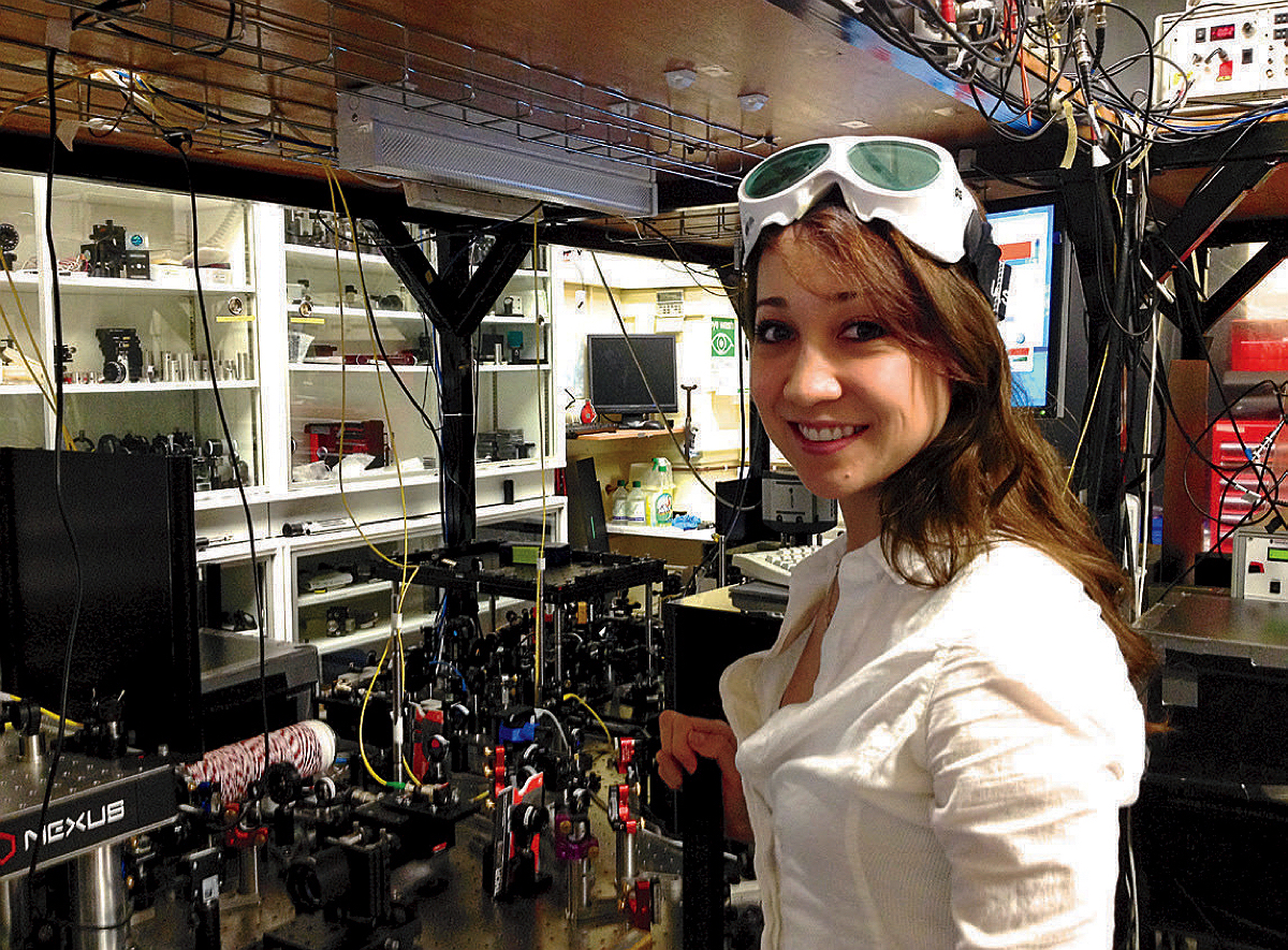 Moore with white goggles on her head in the atomic laser lab at the University of Oxford. 