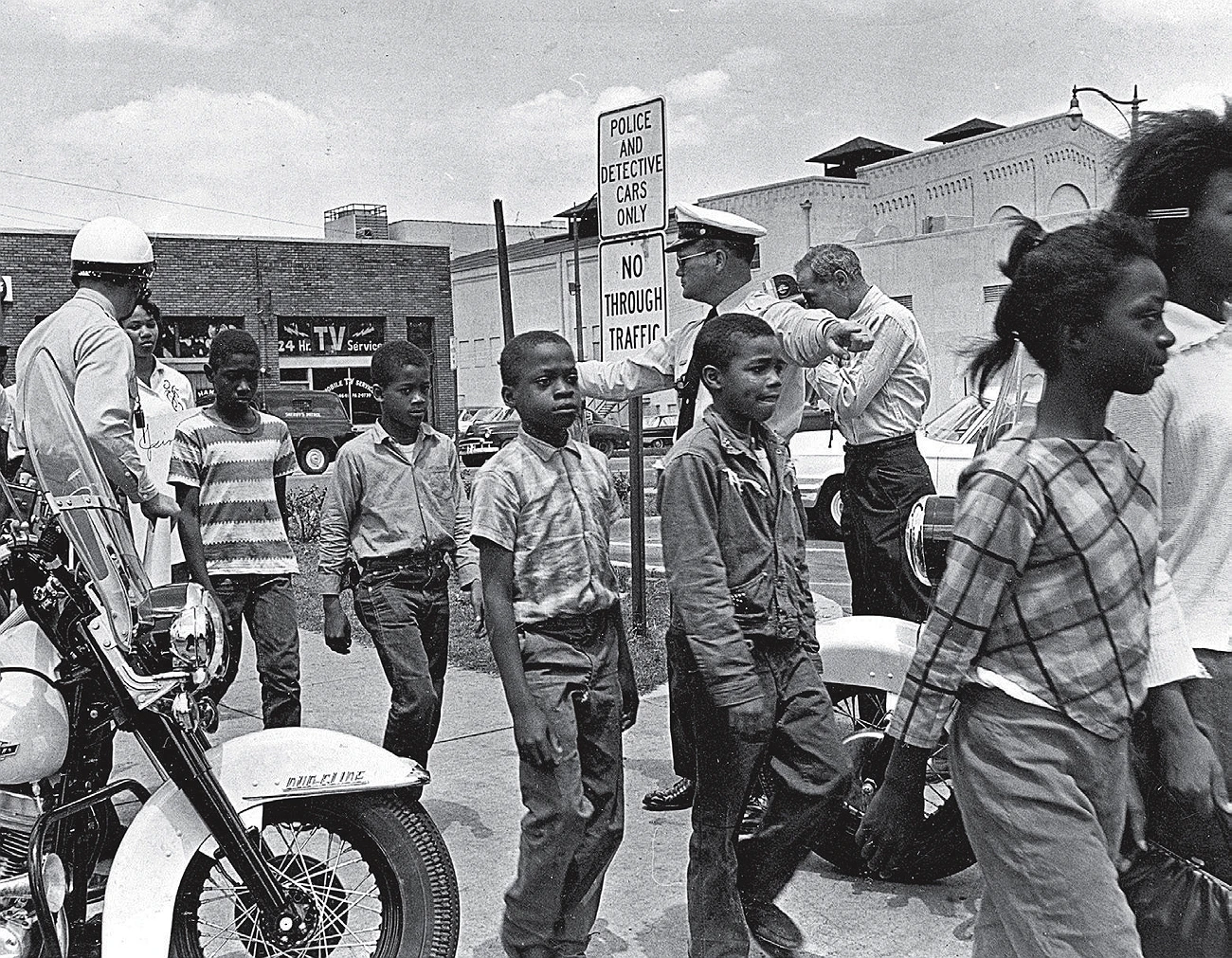 Black children being escorted by police officers during a civil rights protest in the 1960s.