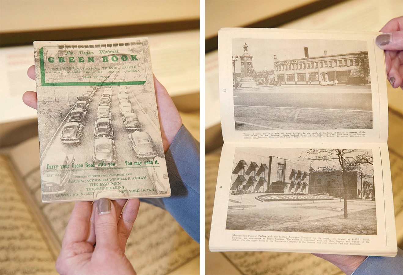 Person holds 1949 Green Book, open to black-and-white photos of buildings.
