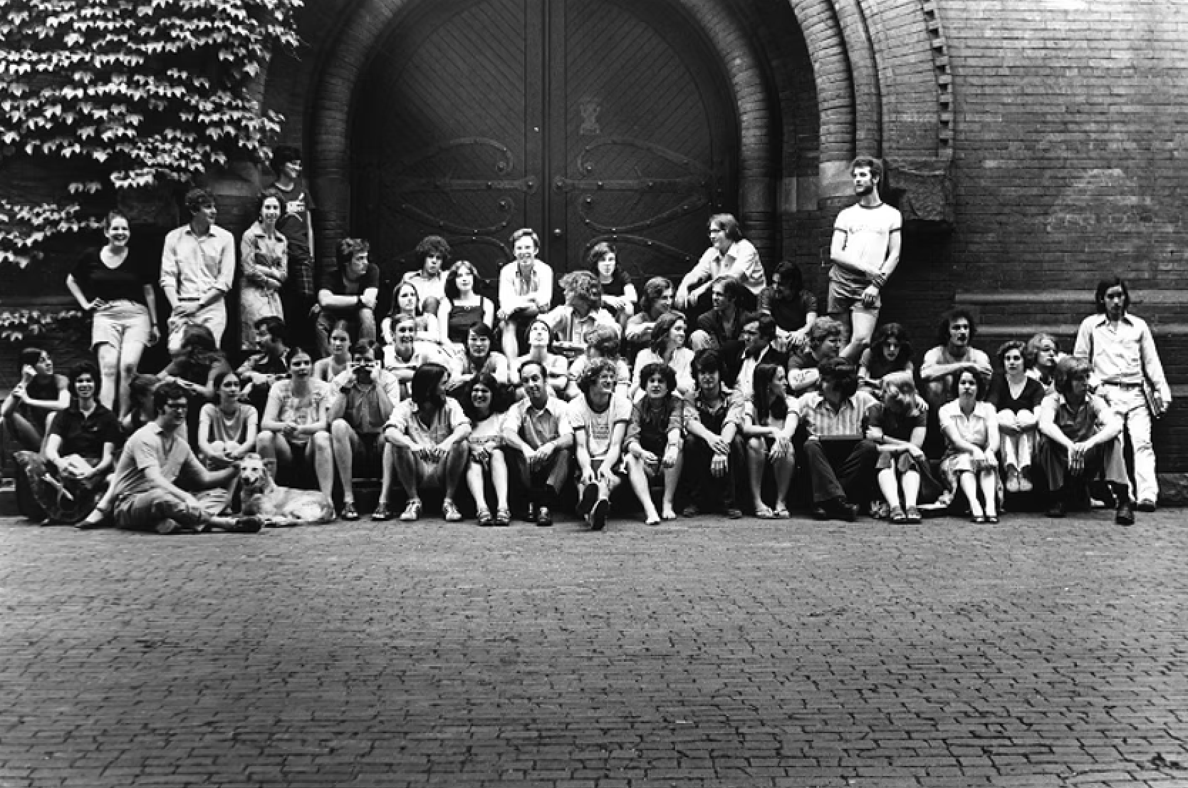 Members of the original chorus from 1976 standing in front of Sever's 