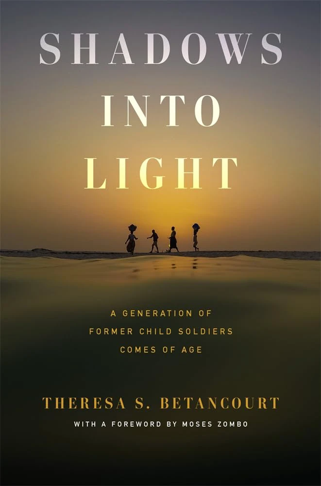 Book cover for "Shadows into Light: A Generation of Former Child Soldiers Comes of Age" by Theresa S. Betancourt with the silhouette of four people walking on the beach at sunset