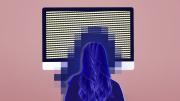 Woman sitting in front of a screen with a blue glow