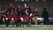 Harvard players celebrate after interception