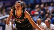 Elena Rodriguez dribbling the basketball up the court 