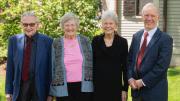 group of four people standing outside 