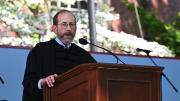 Alan Garber stands at podium under tent