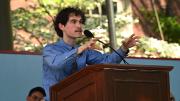 Man at podium addressing audience