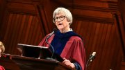Drew Gilpin Faust in robes at the podium in Sanders Theater