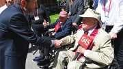 President Alan Garber greets Bertram A. “Bert” Huberman ’44  and George Post ’45