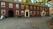Harvard Yard with a message drawn in chalk on the ground 