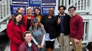 Senator Warren and Representative Ayanna Pressley with Harvard Democrats members in front of campaign signs for their re-election.