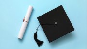 Graduation hat and diploma on color background