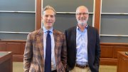 Noah Feldman and Derek Penslar pictured in a lecture room with blackboards in the background